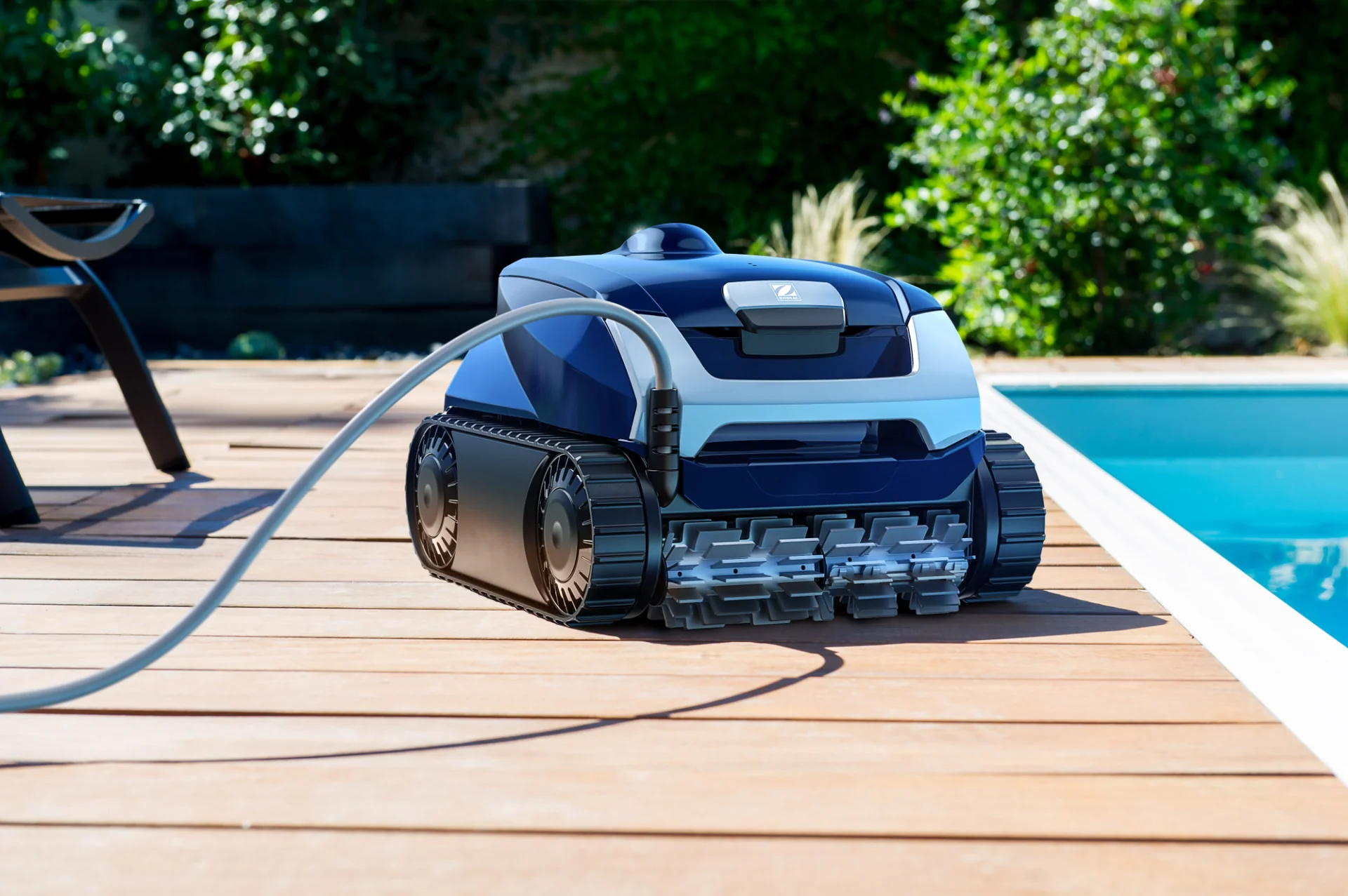 Robot nettoyeur RE 4100 posé sur une terrasse en bois au bord d’une piscine